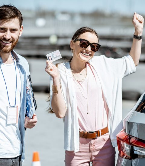 Instructor with student at the driver's school outdooors